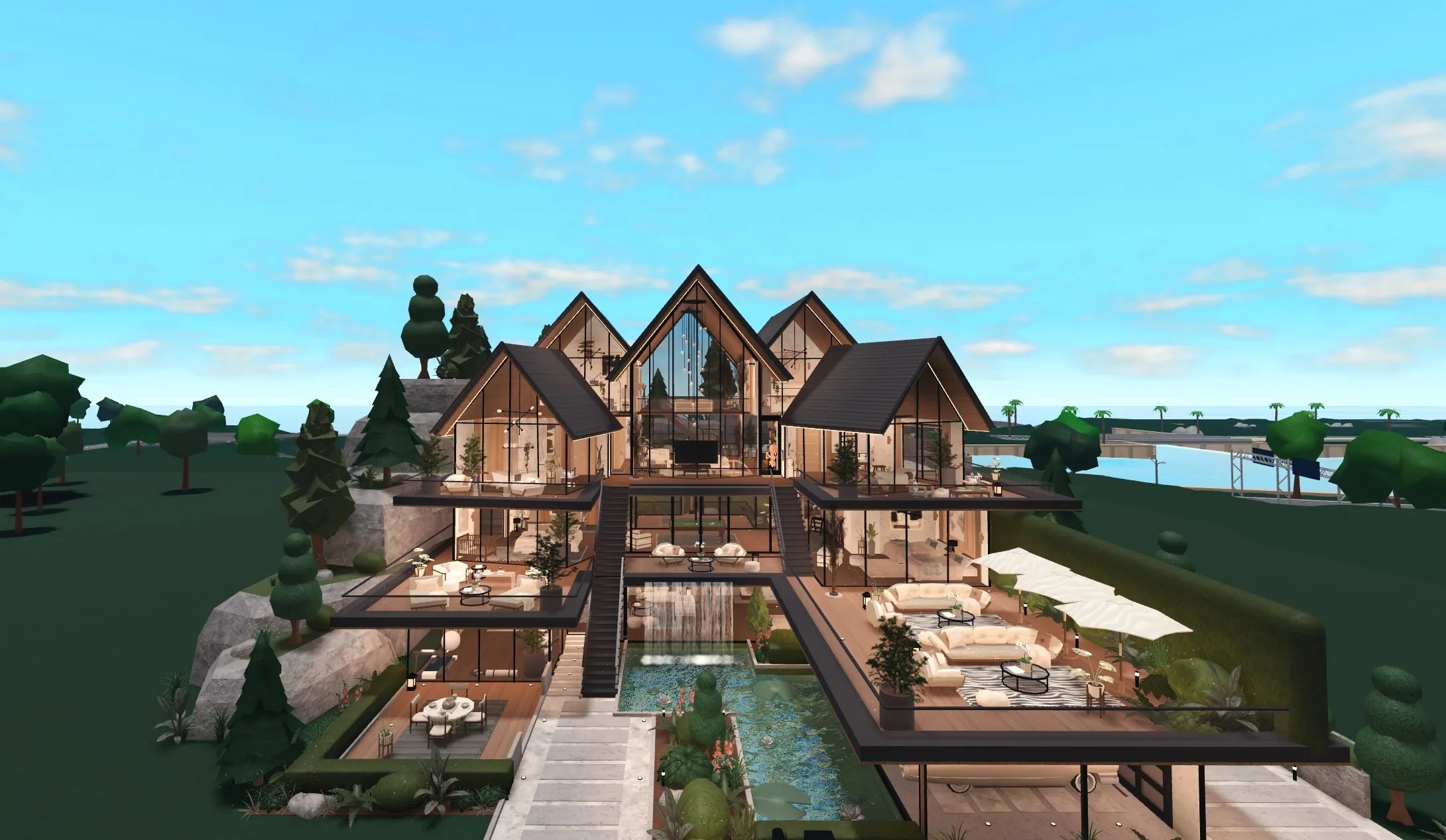 Aspen Glass House, a modern Bloxburg house with tall glass gables, dark timber and a pool courtyard
